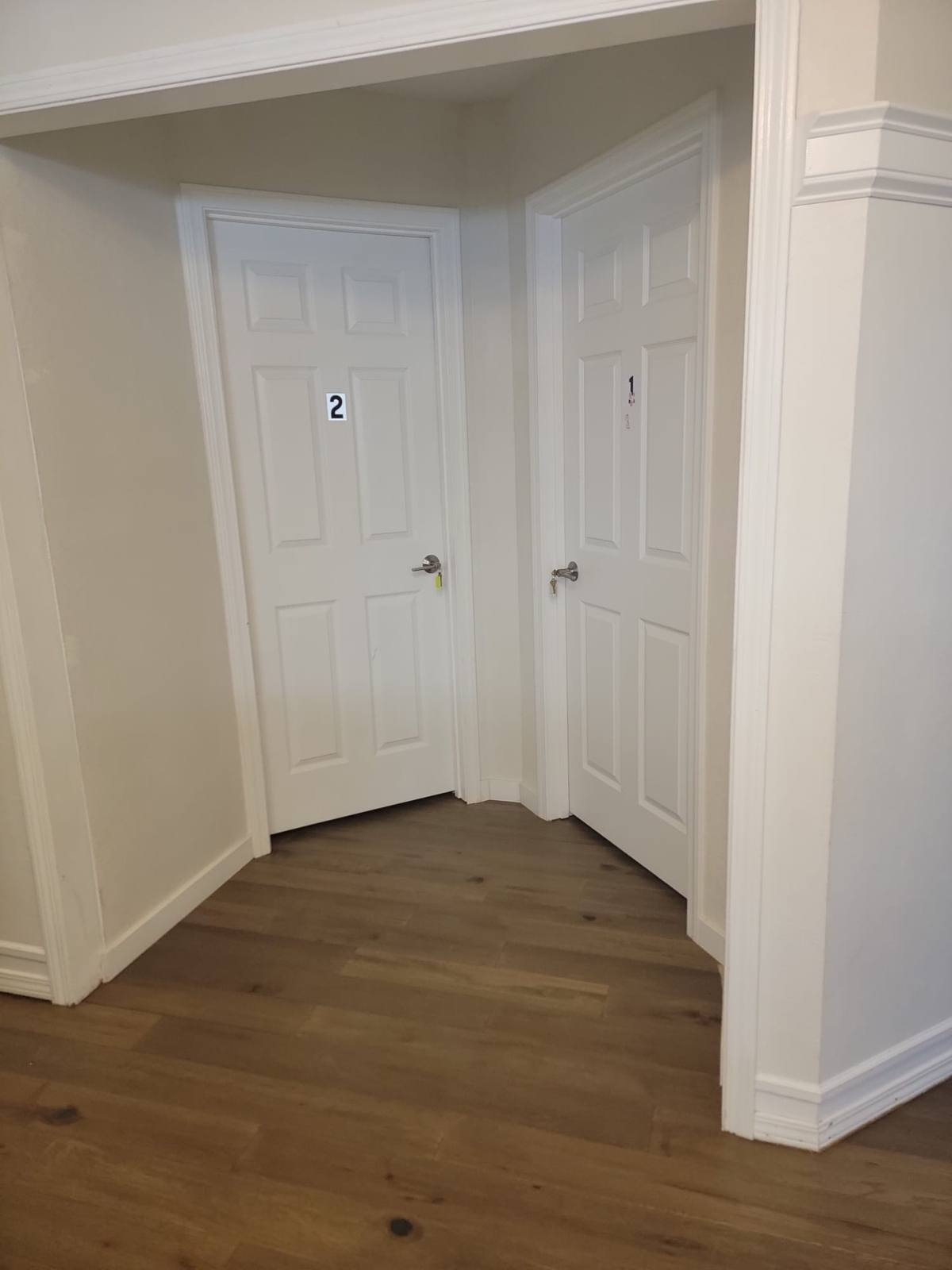 Two bedroom doors off a level hallway.